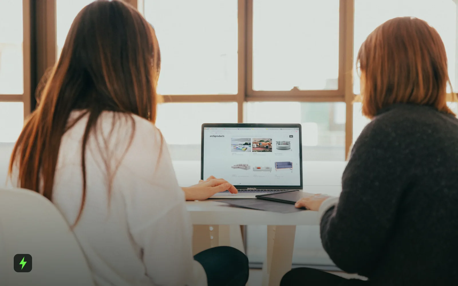 Two colleagues reviewing a website on a laptop